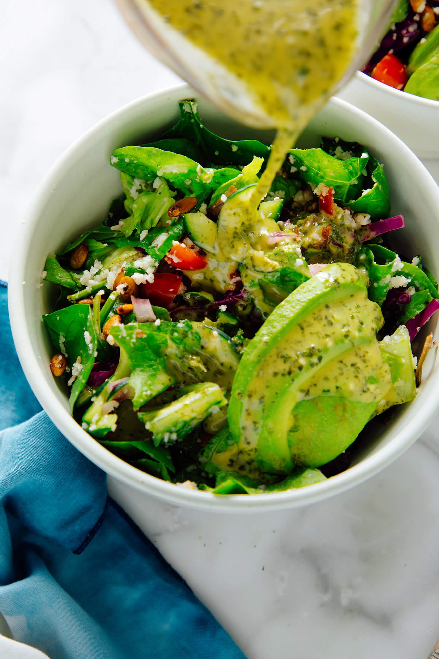 cilantro lime dressing pouring onto salad